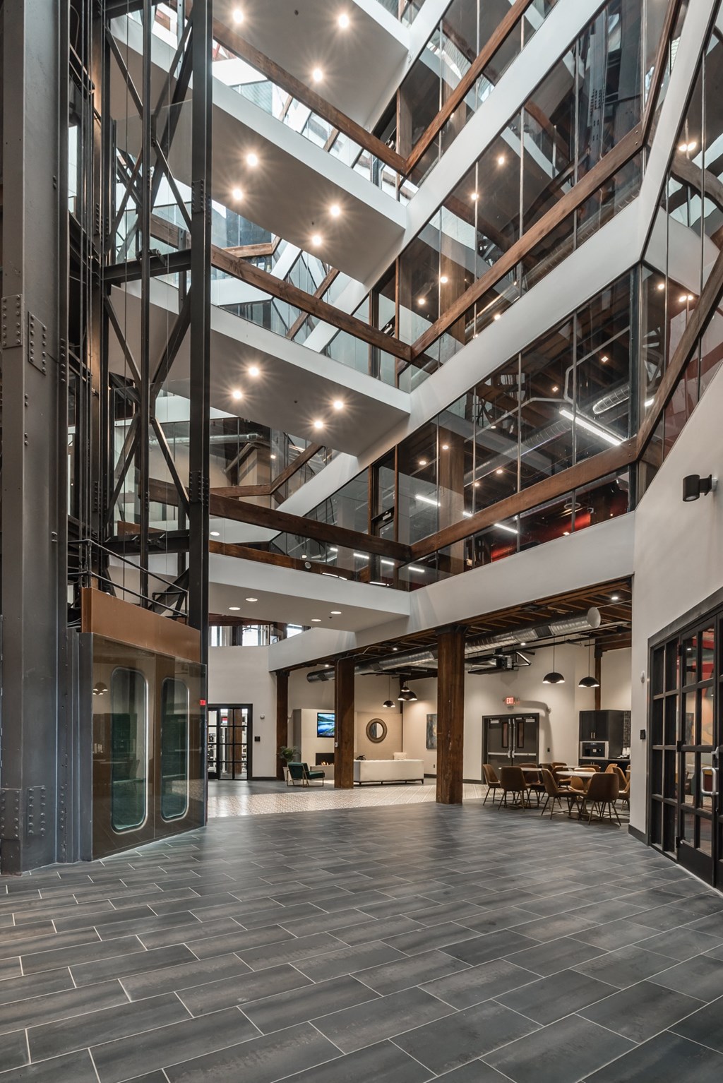the lobby of a large building with a glass ceiling and a staircase