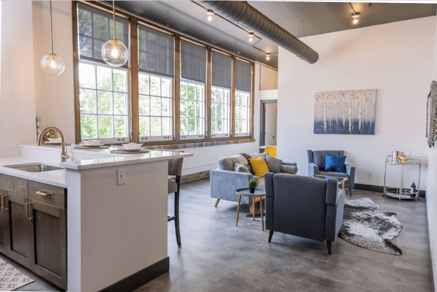 a living room with a kitchen and an open floor plan
