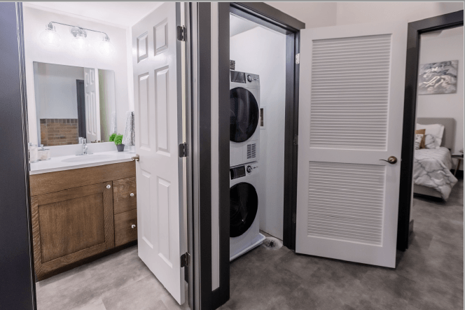 a small bathroom with a washer and dryer in a closet