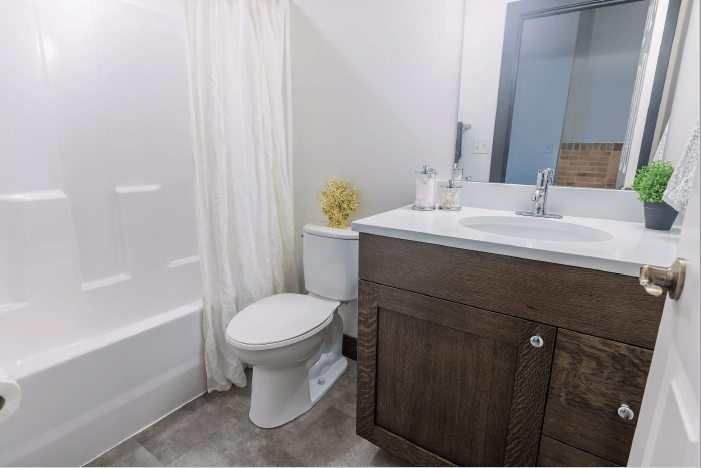 a bathroom with a toilet and a sink and a bath tub