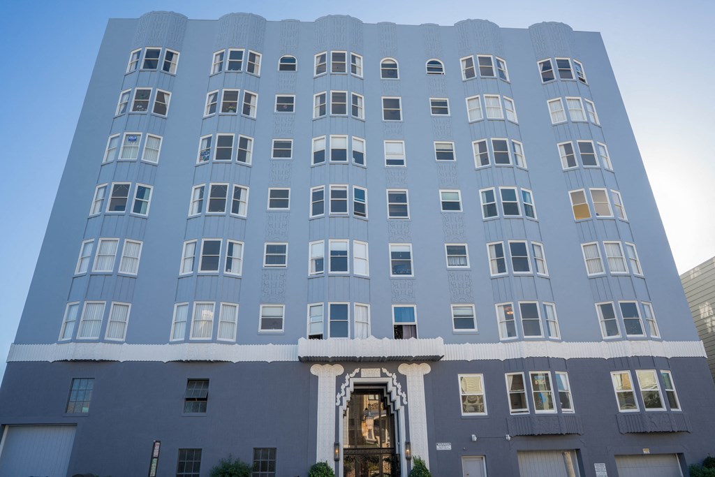 a blue building with white windows and a blue sky