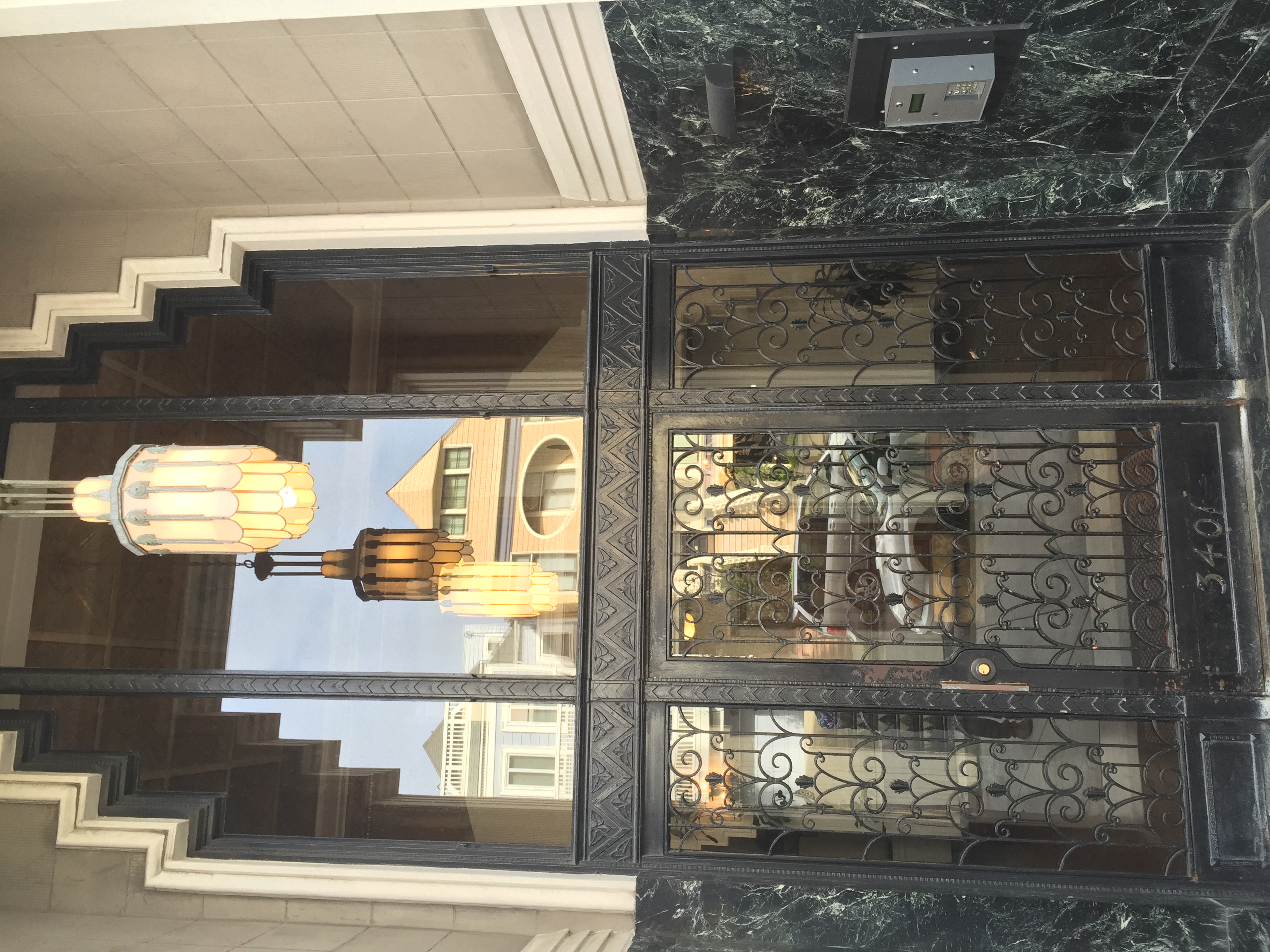 a glass door with a reflection of a staircase