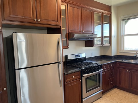 a kitchen with stainless steel appliances and wooden cabinets