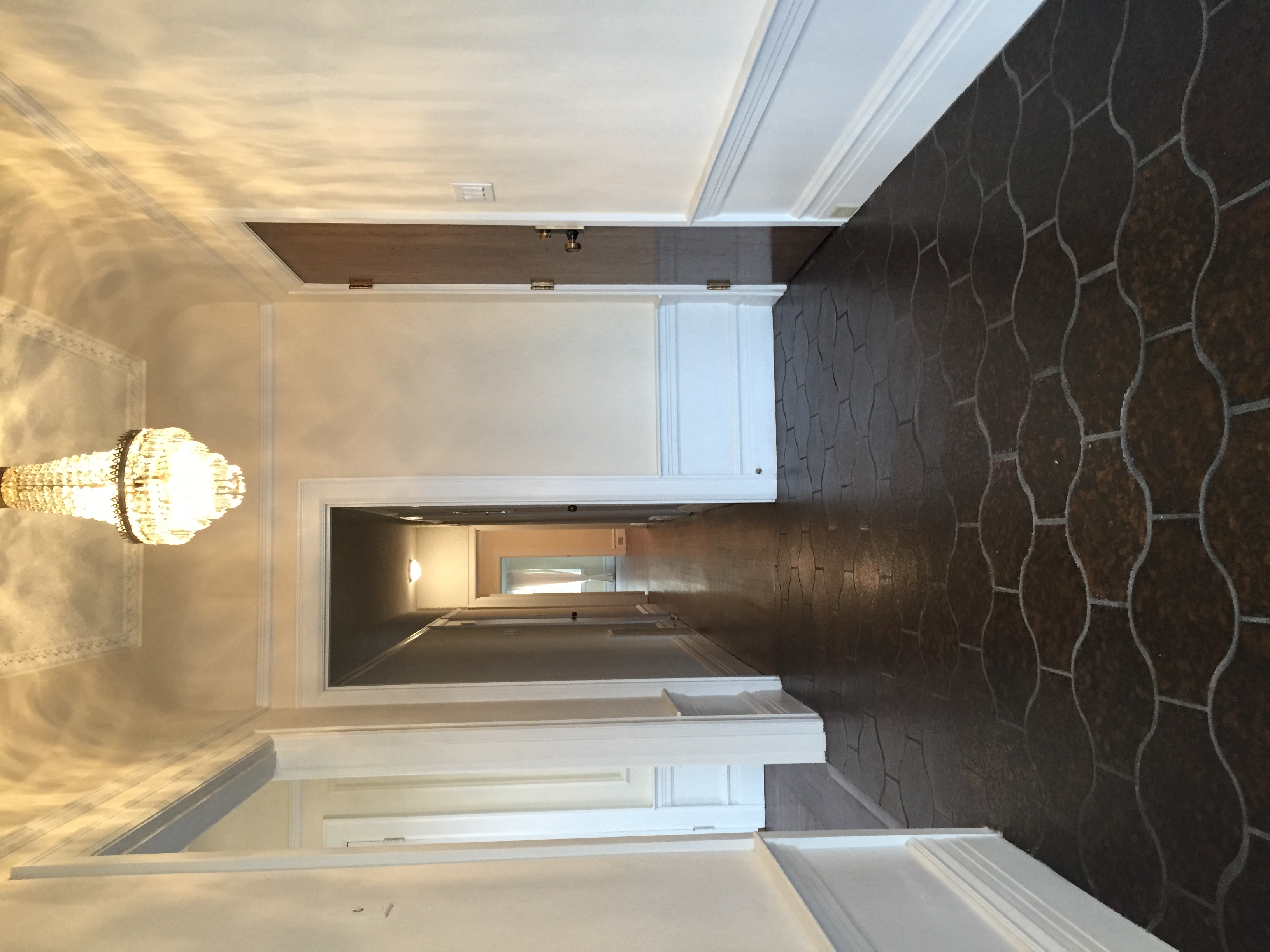 a kitchen with a black wall and white cabinets and a white sink