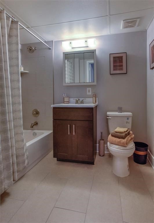 a bathroom with a toilet and a sink and a shower