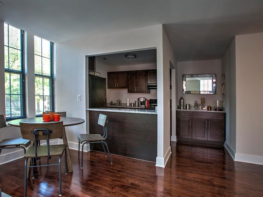 a kitchen and dining room with a table and chairs