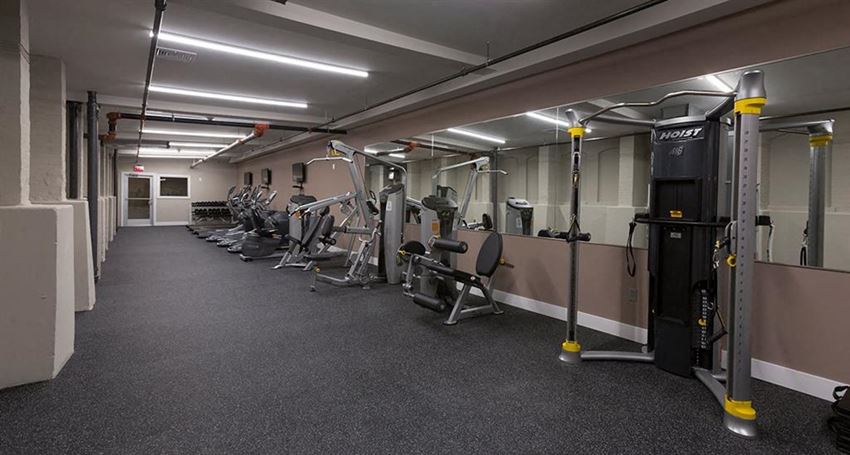 a gym with a lot of exercise equipment in it