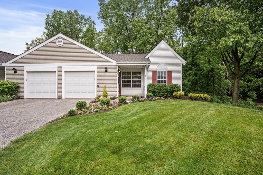 a white house with a lawn in front of it