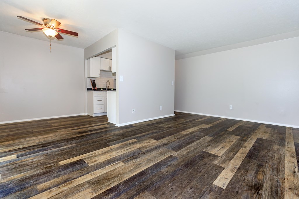 a living room with hardwood floors and a ceiling fan