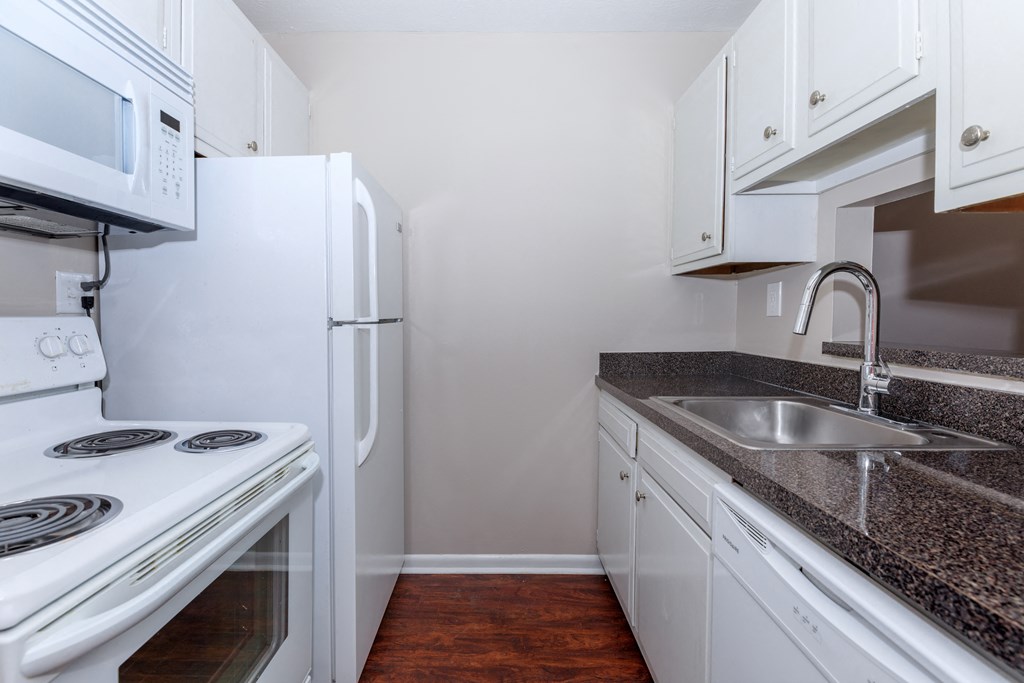 a kitchen with white appliances and white cabinets