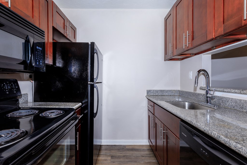 a kitchen with black appliances and granite countertops