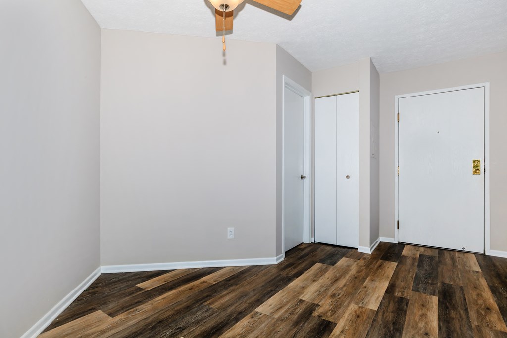 a living room with hardwood floors and white walls