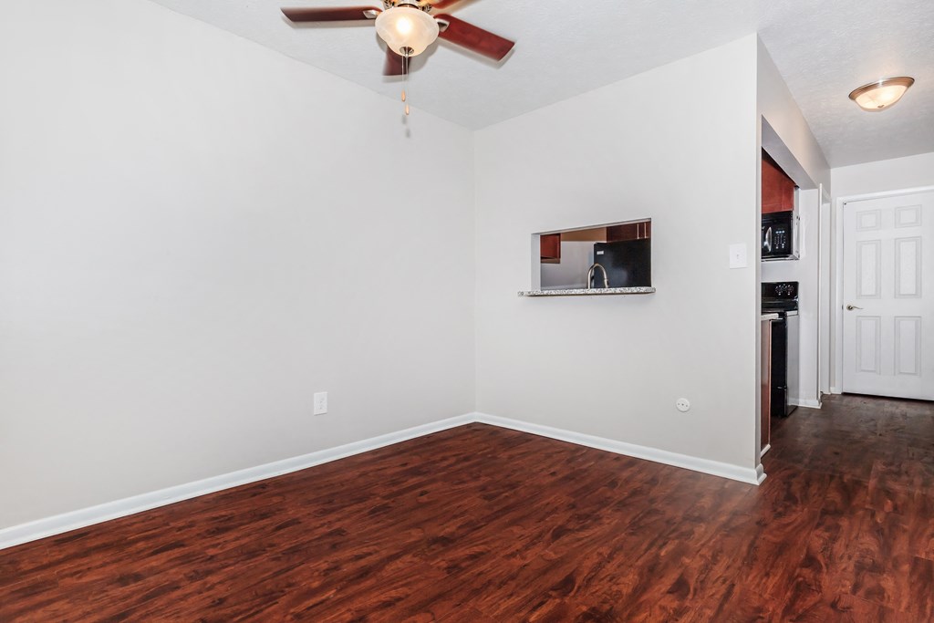 a living room with hardwood floors and a ceiling fan