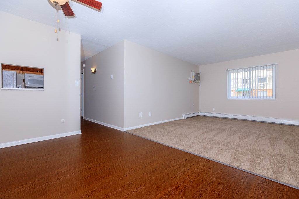 a bedroom with hardwood floors and a ceiling fan