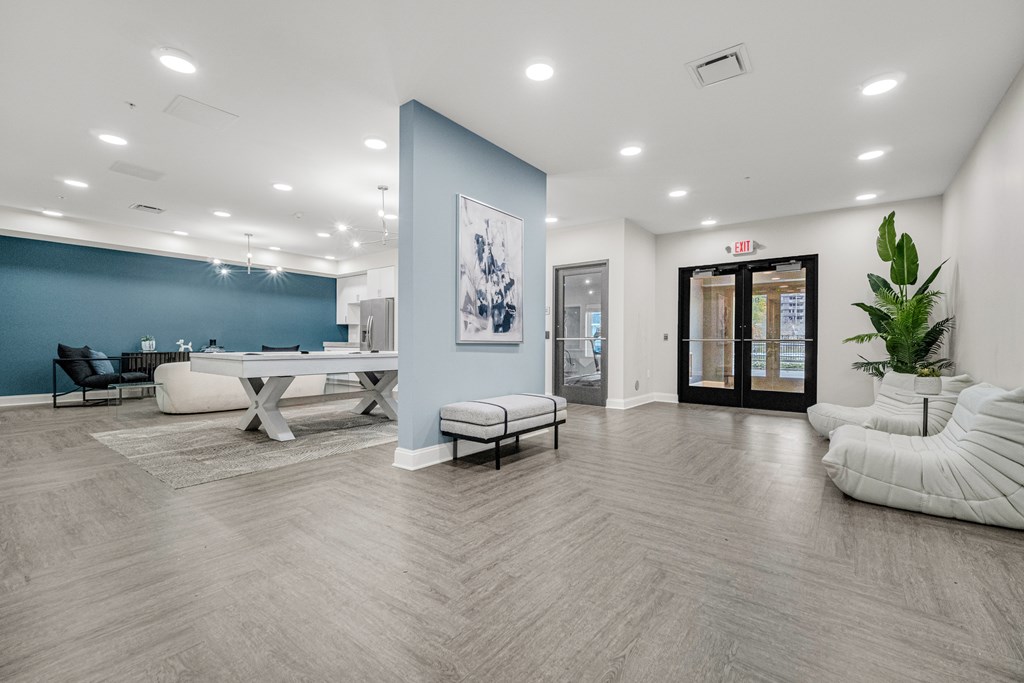 A spacious room with a blue accent wall and a white chair. at Park Lamont Townhomes Apartments, Ohio, 44106