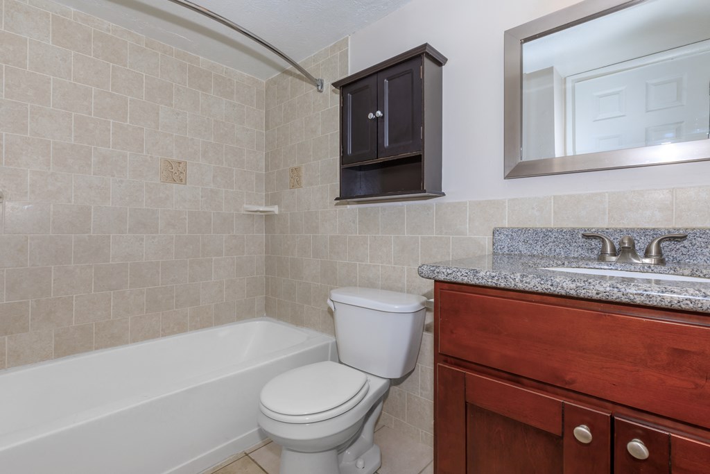 a bathroom with a toilet sink and bathtub
