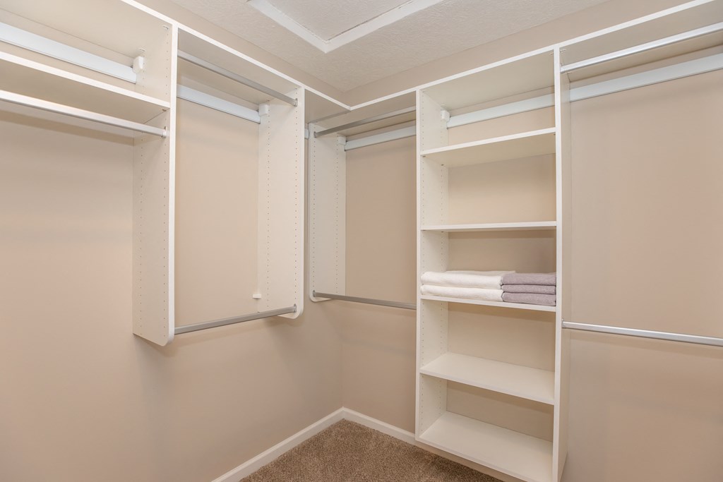 spacious walk in closet with built in shelving