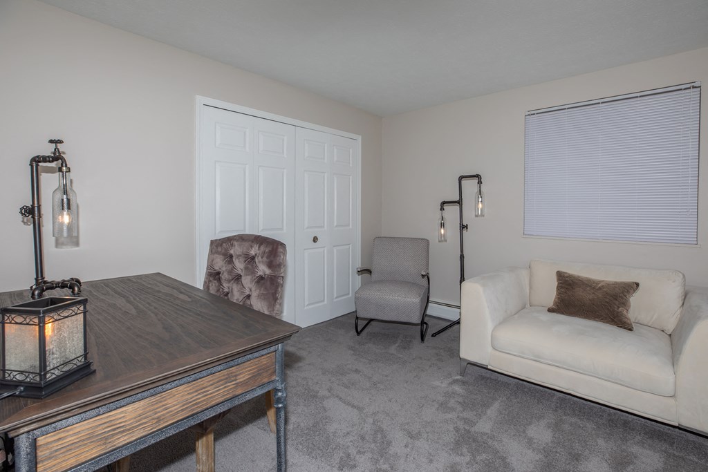 a living room with a couch and two chairs