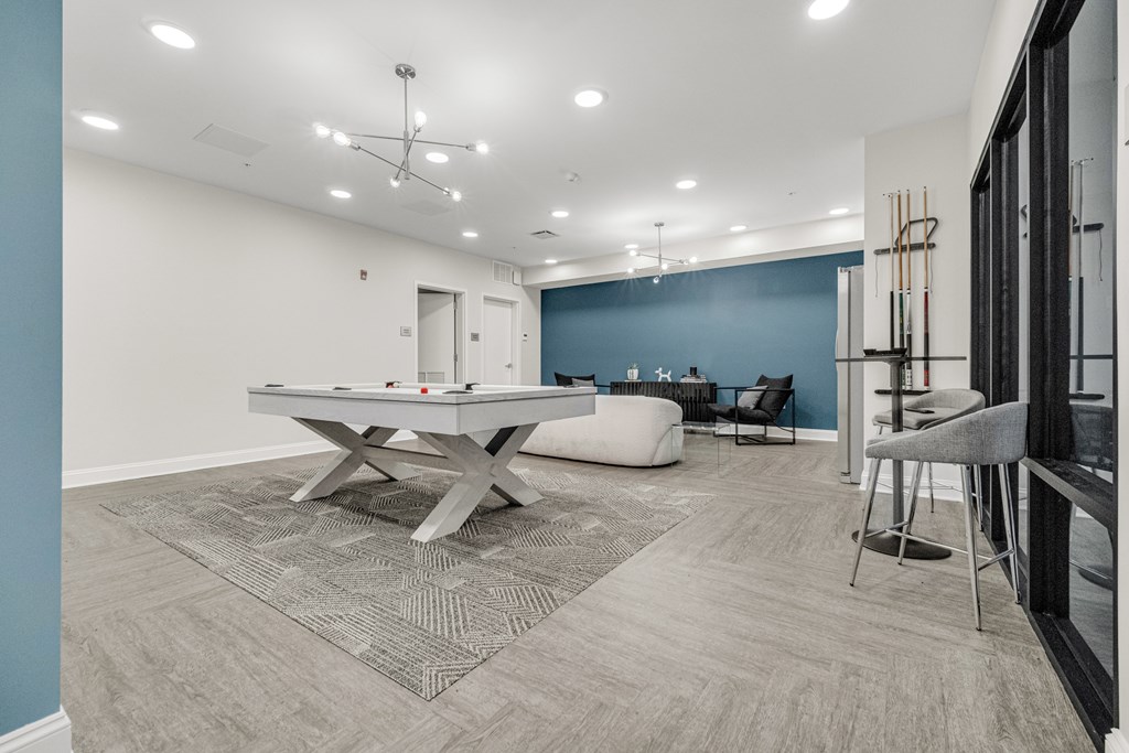 A room with a pool table and chairs. at Park Lamont Townhomes Apartments, Ohio