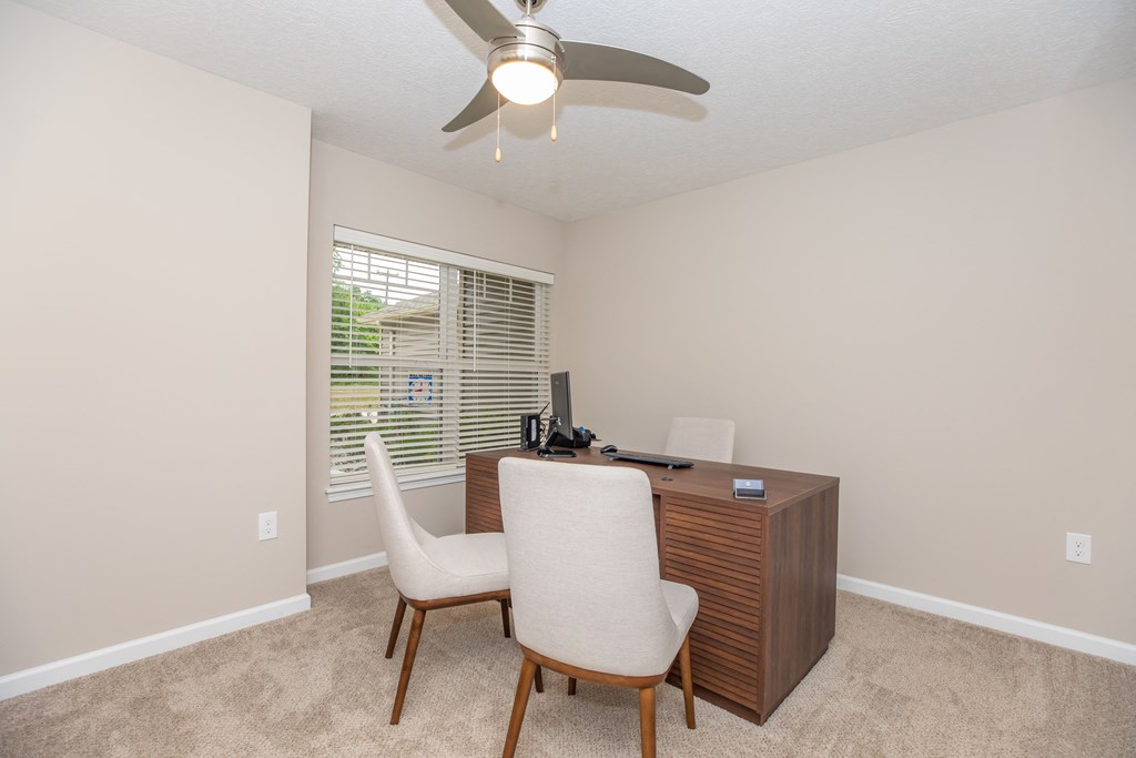 Second bedroom or office with plush carpeting and natural lighting