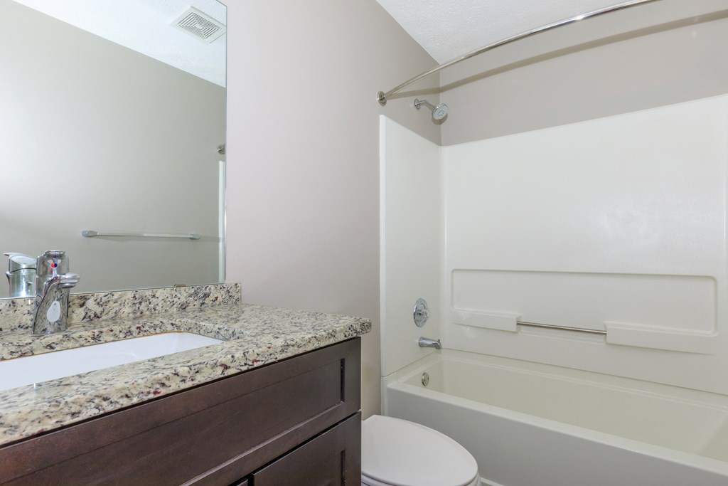 a bathroom with a sink toilet and bathtub