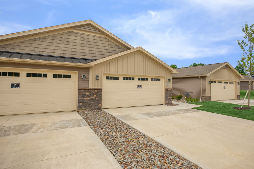 a house with a driveway and two garage doors