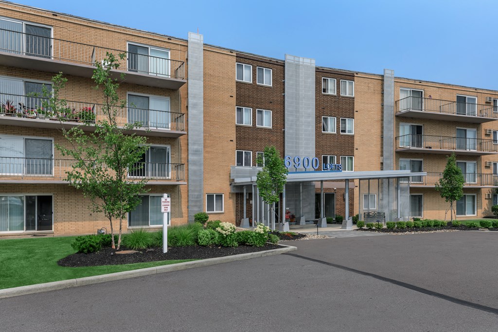 a large brick building with trees in front of it