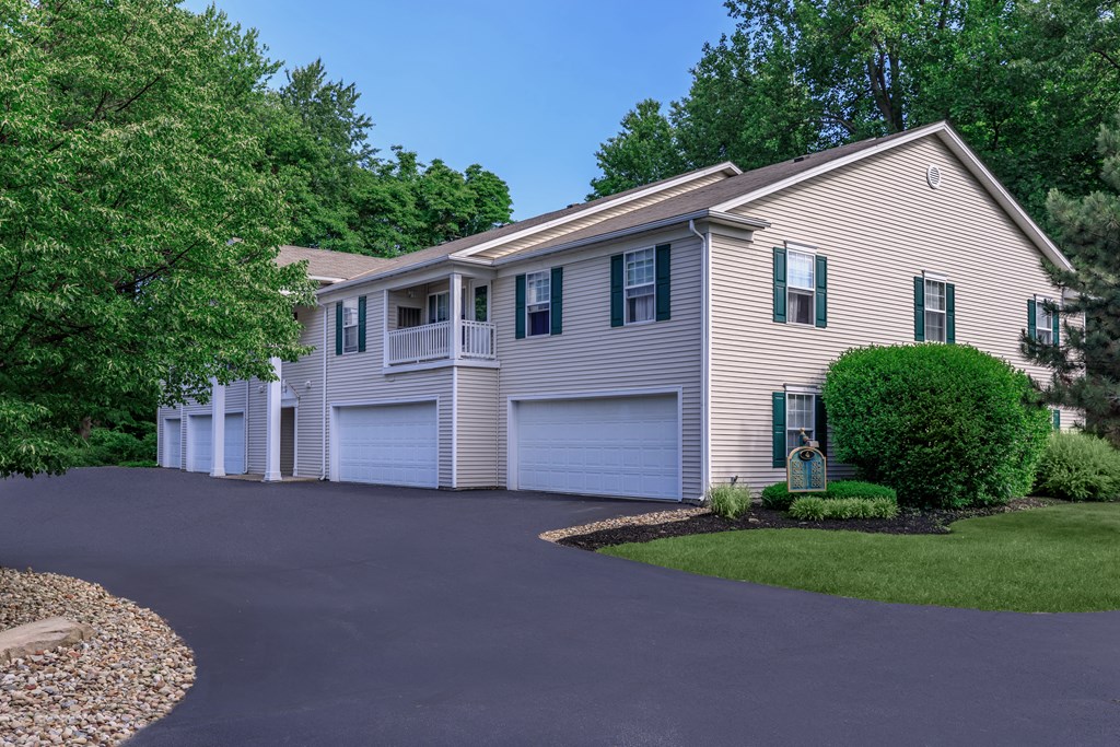 a house with two garages and a driveway