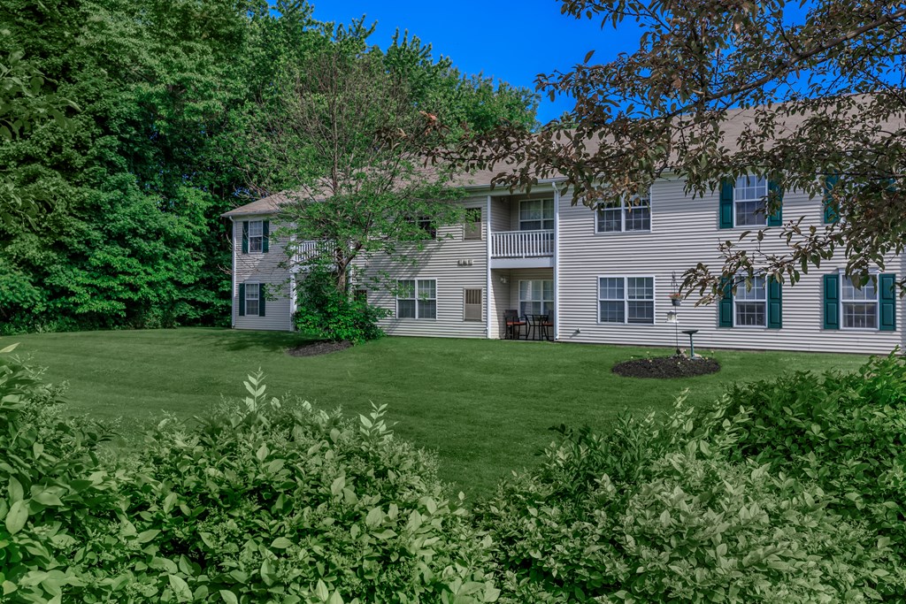 a large white house with a large green lawn
