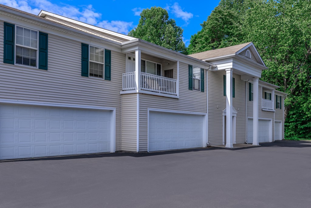 a house with two garages and a balcony