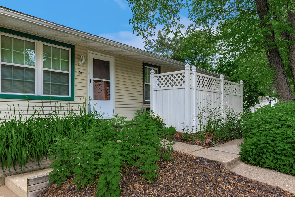 a white fence in front of a house