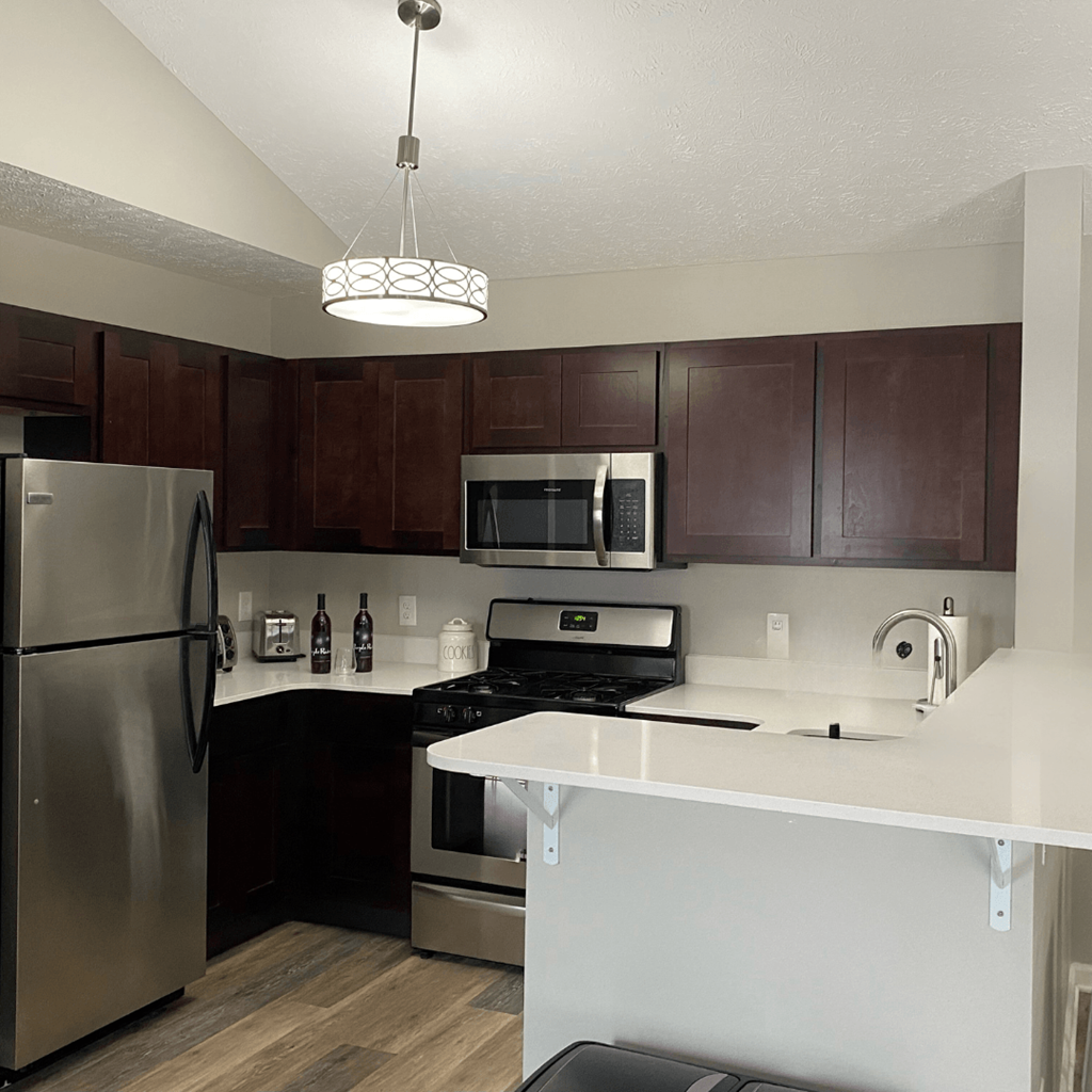 a kitchen with stainless steel appliances and a white counter top