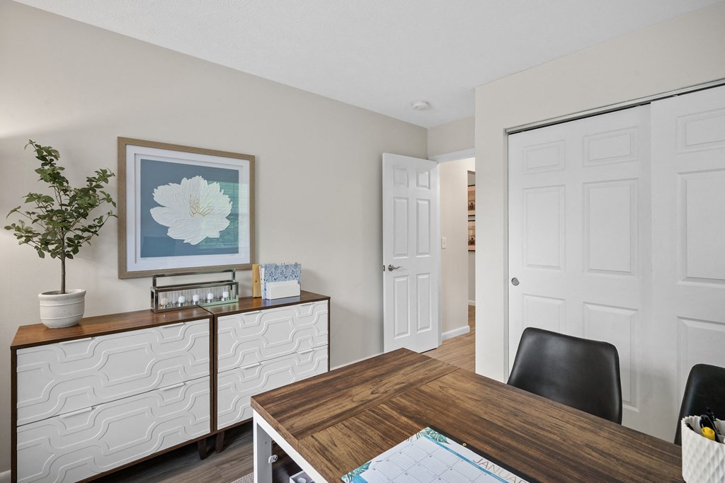 a dining room with a table and a door to a hallway