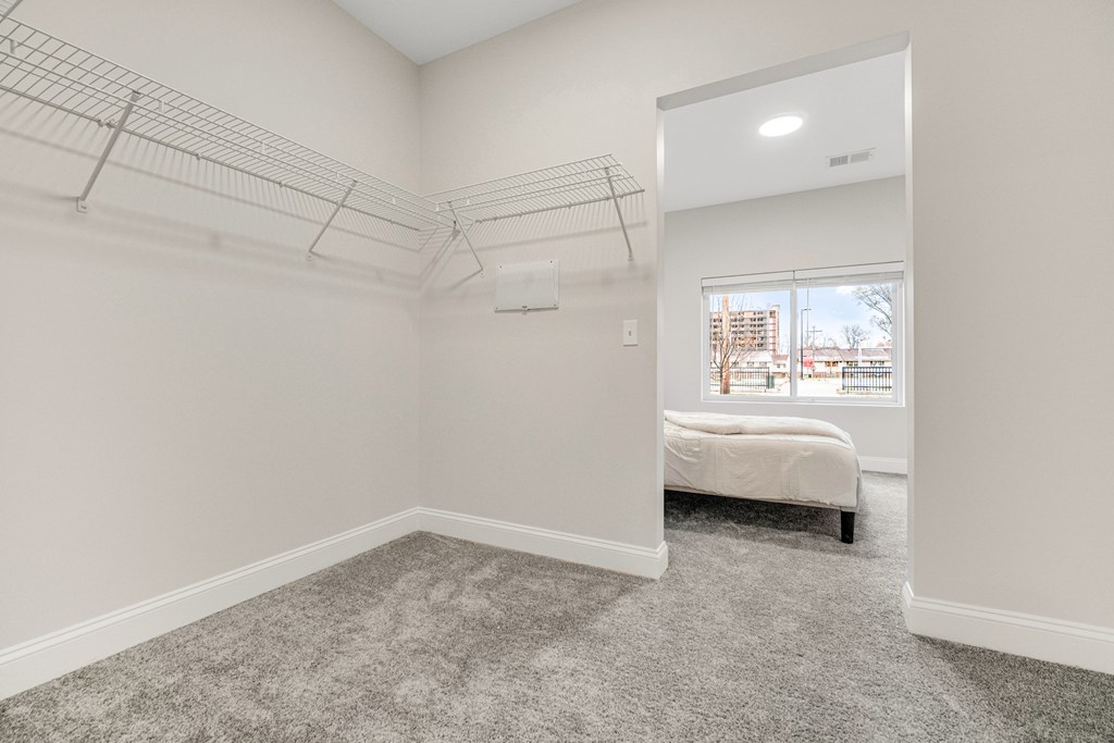 A bedroom with a bed and a window. at Park Lamont Townhomes Apartments, Cleveland, Ohio