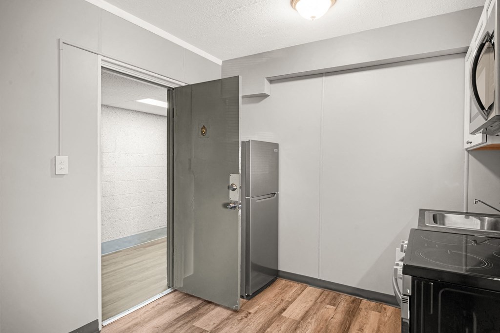 a kitchen with a stainless steel refrigerator and a glass door