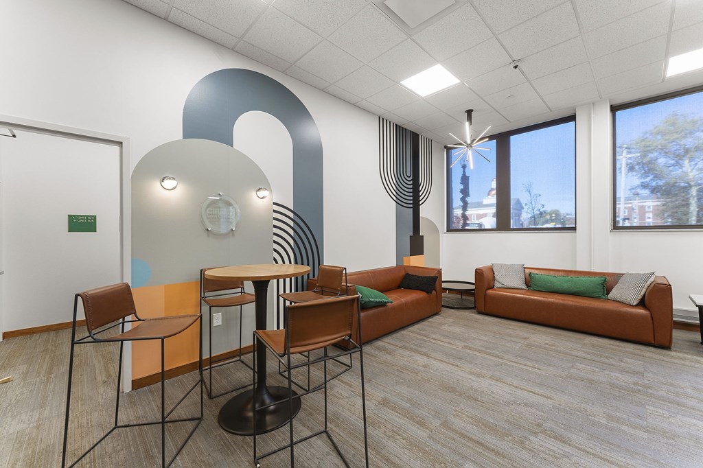 A modern office space with a large table and chairs.