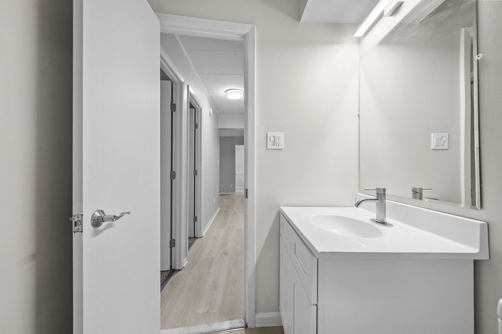 an empty bathroom with a sink and a mirror