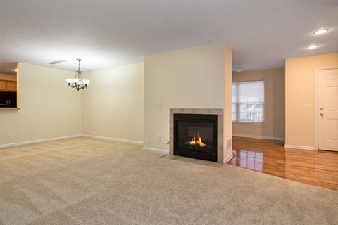 A living room with a fireplace and a chandelier.