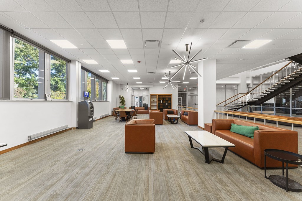 A spacious room with wooden floors and furniture.