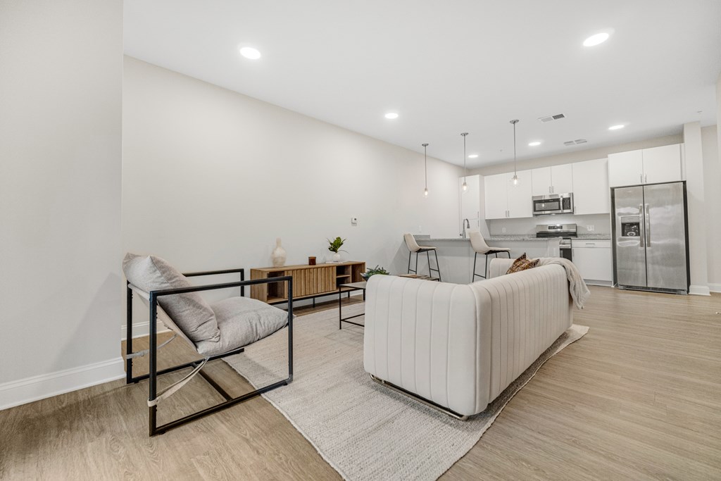 A modern living room with a white sofa and a chair. at Park Lamont Townhomes Apartments, Cleveland, OH, 44106