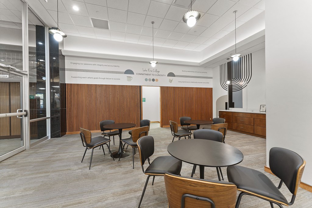 A conference room with a long table and chairs.