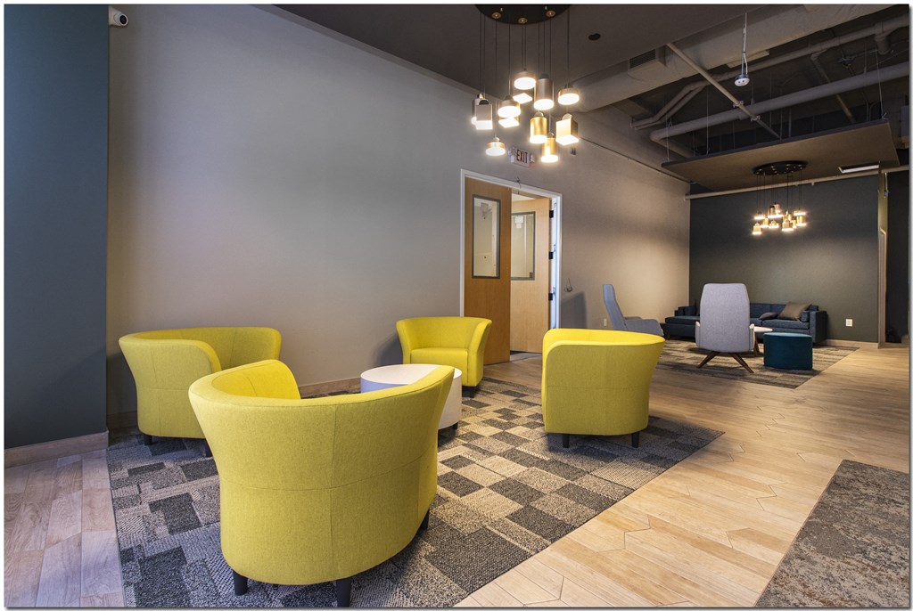 a room with yellow chairs and gray walls