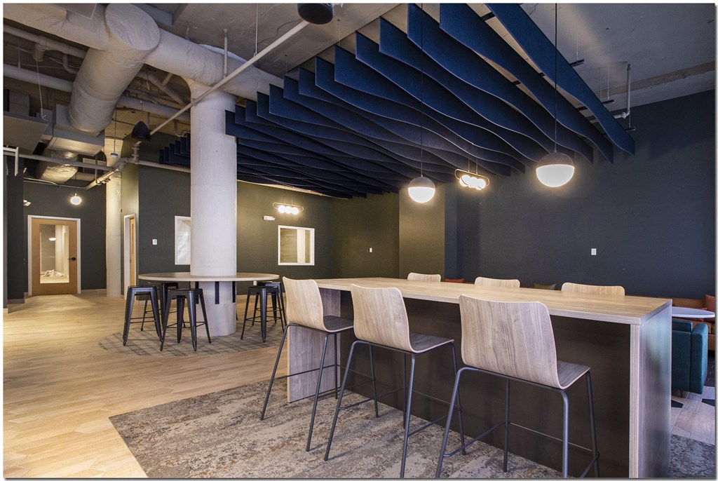a room with a long table with chairs and a long bar in the middle of the room