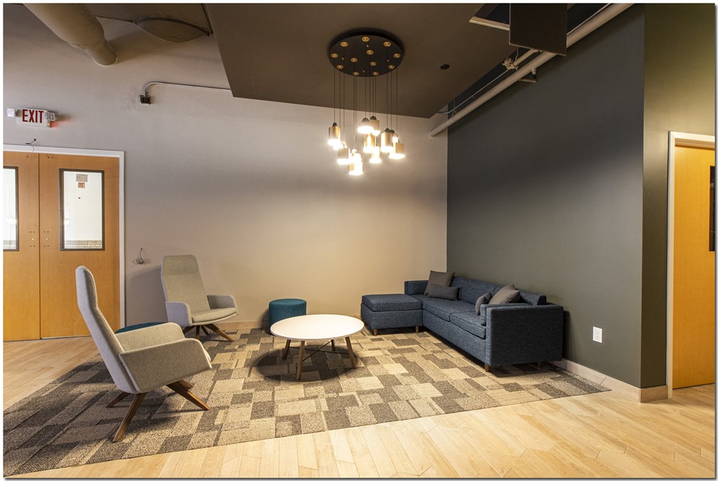 a lounge area with couches chairs and a coffee table