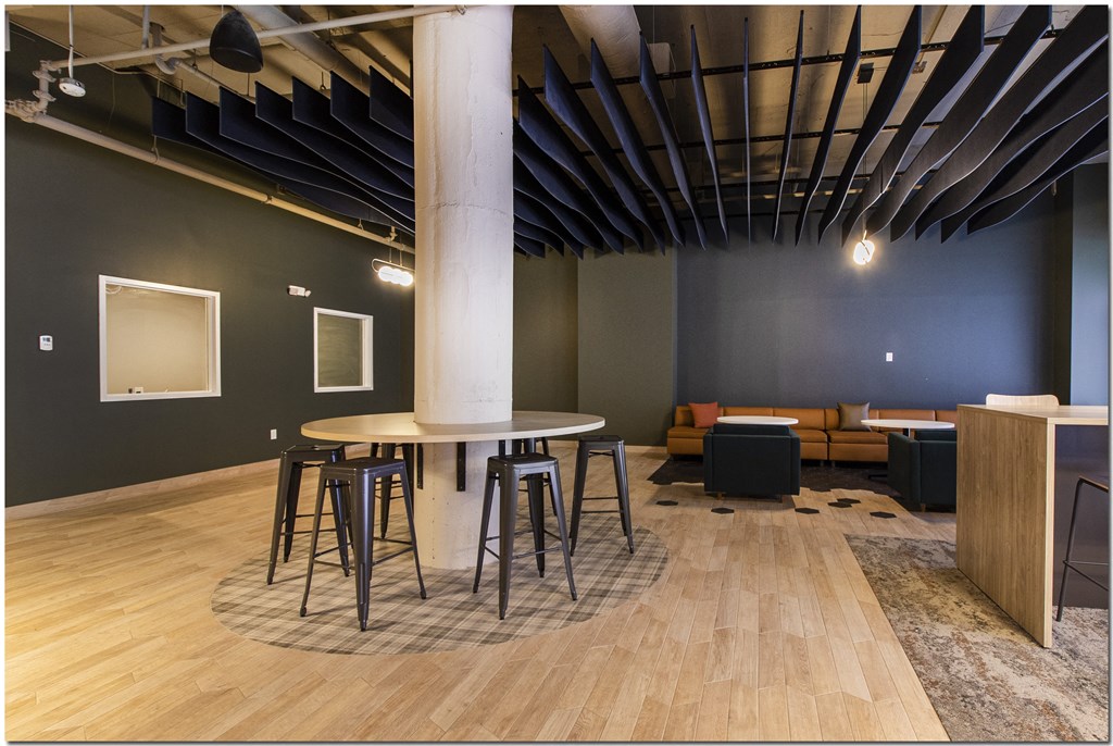 a communal area with a round table and stools