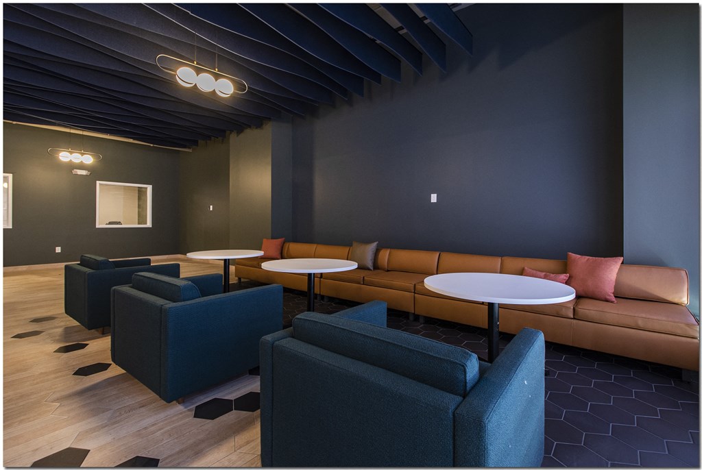 a lounge area with couches tables and chairs