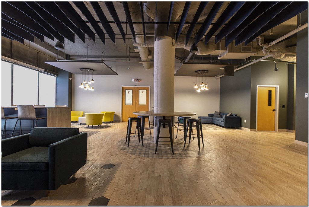 a large room with a round table and chairs
