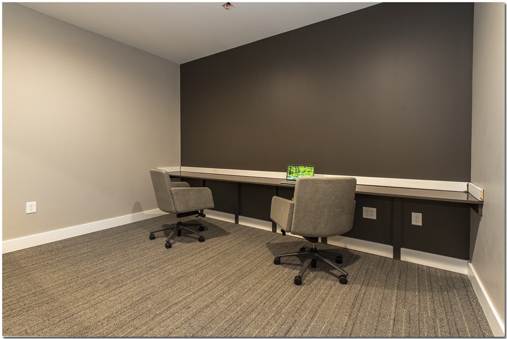 an empty office with two desks and two chairs