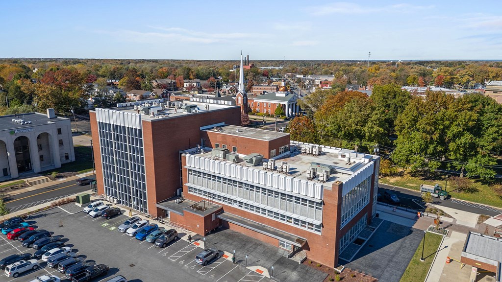 A large building with a parking lot in front of it.