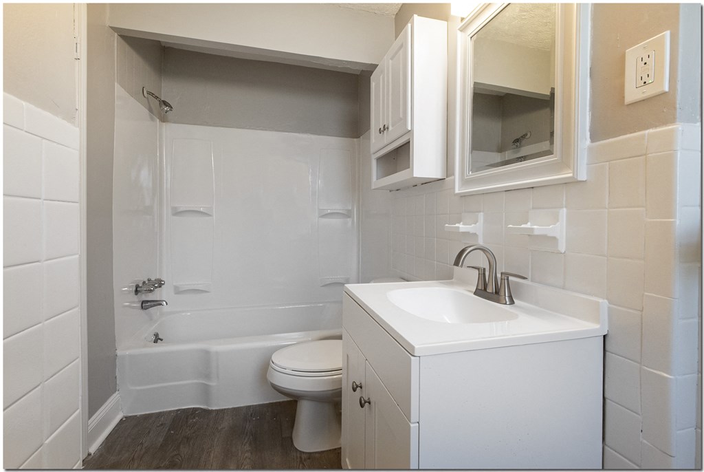 a bathroom with a toilet sink and bathtub